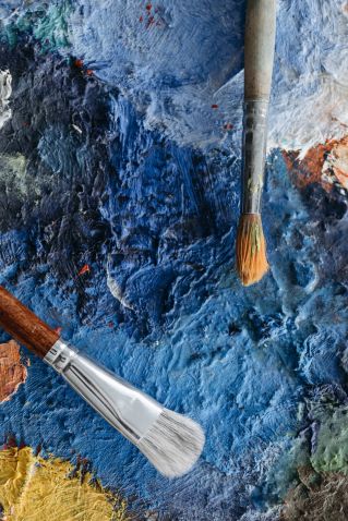 Close-up of Paintbrushes on a Rough Surface with Blue Paint