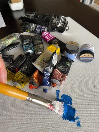 Close-up of Paintbrushes on a Rough Surface with Blue Paint